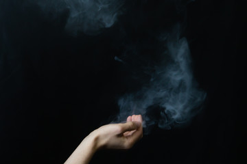 Smoke in hand. abstract fog. hand creates a magic spell