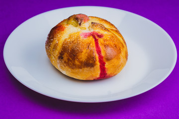Bun with red sweet jam. sweet baking close up