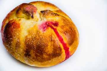 Bun with red sweet jam. sweet baking close up