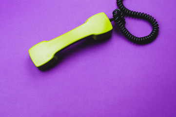 Retro telephone handset. phone receiver isolated on purple background. old communication technology