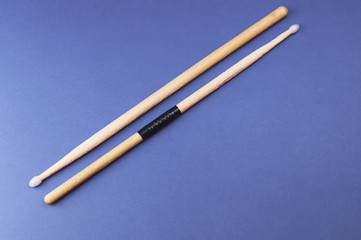 A pair of wooden drumsticks isolated on color background