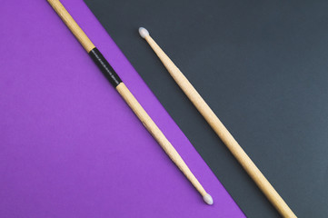 A pair of wooden drumsticks isolated on color background