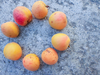 many apricots on a concrete wall. Closeup of fresh apricots as a background. place for text