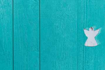 Colourful blue-green boards of wood with an angel, backdrop and copy space