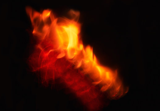 Fire flames on Abstract art black background, Burning red hot sparks rise.