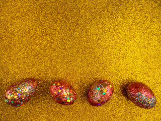 Red golden eggs. A symbol of making money and successful investment on festive gold background