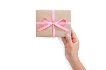 Female hands holding present box or gift box package in craft paper