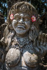 Fototapeta na wymiar Tempelfigur mit Blumen geschmückt in Ubud, Bali