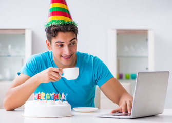 Young man celebrating birthday alone at home