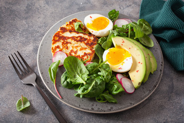 healthy keto paleo diet breakfast: boiled egg, avocado, halloumi cheese, salad leaves