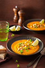 creamy carrot chickpea soup on dark rustic background