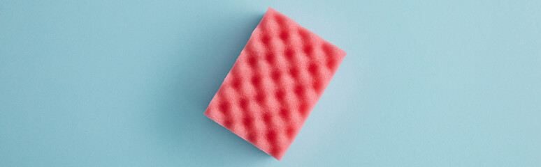 panoramic shot of pink sponge for house cleaning on blue