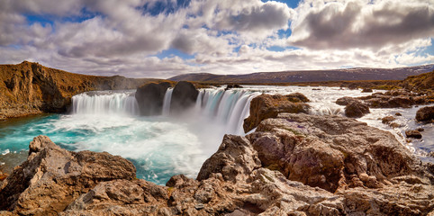 Panorama of most famous place of Golden Ring Of Iceland. Godafoss waterfall near Akureyri in the Icelandic highlands, Europe. Popular tourist attraction. Travelling concept background. Postcard.