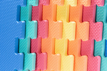 Macro photo of the details of a foam. Colored rubber mat puzzle for children.