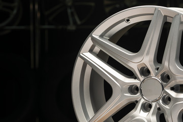 alloy wheel silver, rim new car wheel on a black background close up. Copyspace copy space, front...