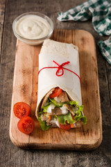 Doner kebab or shawarma sandwich on wooden table
