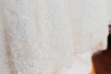 close-up of a wedding dress with embroidery and beads