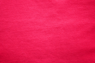 Dark red texture background of cotton fabric detail. Vivid pink or cherry red color cloth, empty material backdrop of casual plain burgundy colour shirt  
