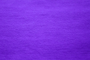 Blue fabric background, empty cloth texture. Simple light purple color shirt, cotton clothes material element close up view 