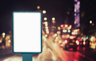 Blank outdoor billboard mockup on city street at night with traffic lights, empty advertisement...