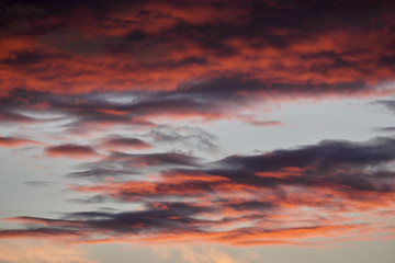 beautiful dramatic sky with dark and bright clouds at sunset, summer landscape, golden sunlight