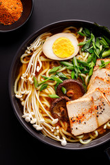 A top view of a bowl of the vegetarian version of traditional Japanese ramen soup.