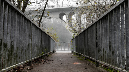 Grey old road under a bridge