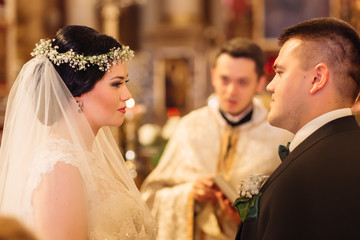 wedding ceremony. couple standing face to face and priest