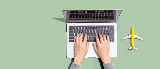 Flights online booking and reservation theme with person using a laptop computer