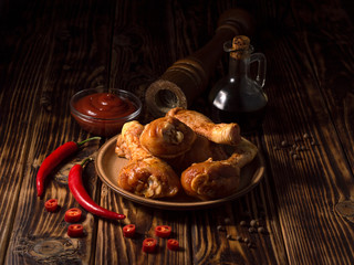 chicken legs marinated in soy sauce on a wooden background.