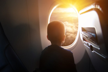 Boy in the plane looking out the window