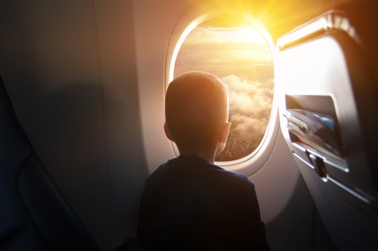 Boy In The Plane Looking Out The Window