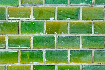 Brick wall as a texture in brilliant green light.