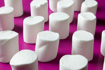 White marshmellow close up on pink background