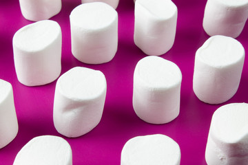 White marshmellow close up on pink background