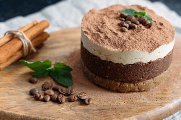  Tiramisu on a beige plate. Coffee with cinnamon. Raw dessert