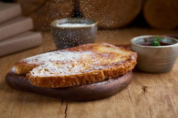 French toasted slices bread and maple syrup. Toasted breads on the plate for breakfast