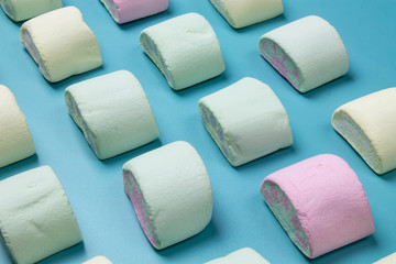 Multicolored marshmallows on a blue background