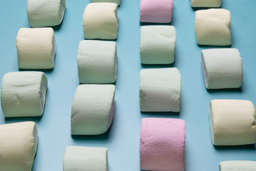 Multicolored marshmallows on a blue background