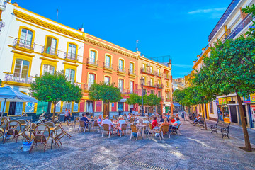 Fototapeta premium The small square with outdoor cafes, Seville, Spain