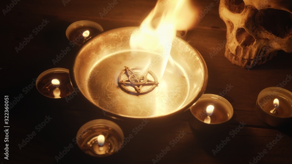 Wall mural Burning pentacle on altar closeup photo