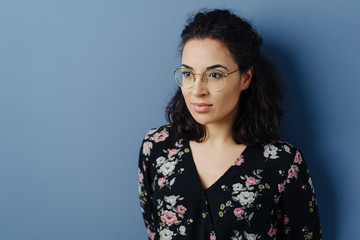 Young brunette woman in glasses looking away