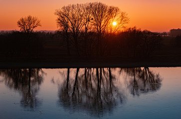 Beautiful sunset with reflections at the river danube near Winzer, Bavaria, Germany