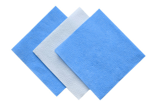 Paper napkins on white isolated, flat lay. Toned in classic blue, trend of 2020.