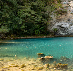 Unique blue mountain lake of the Caucasus located in a gorge with clear water and a depth of more than 100 meters