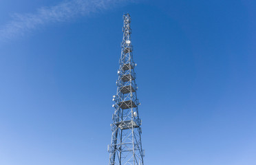 tower with mobile operator antennas on the background sky