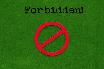 Forbidden! Sign on a green background.