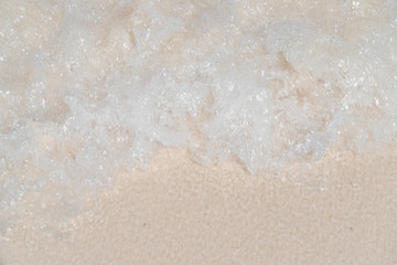 Fototapeta na wymiar Top view of sea water surface wave ripple on the clean white sand from the top