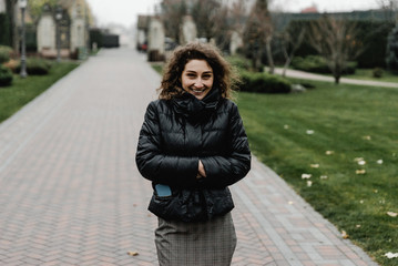 Happy beautiful girl having fun walking outdoor. Portrait of young smiling woman in beret. Lovely girl posing in the old street. Joint vacation concept