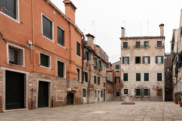 Characteristic square with old well for rainwater called calle in Venice, Italy.